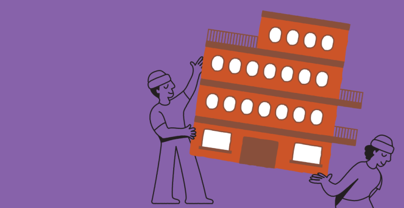 Twee mannetjes verplaatsen een gebouw